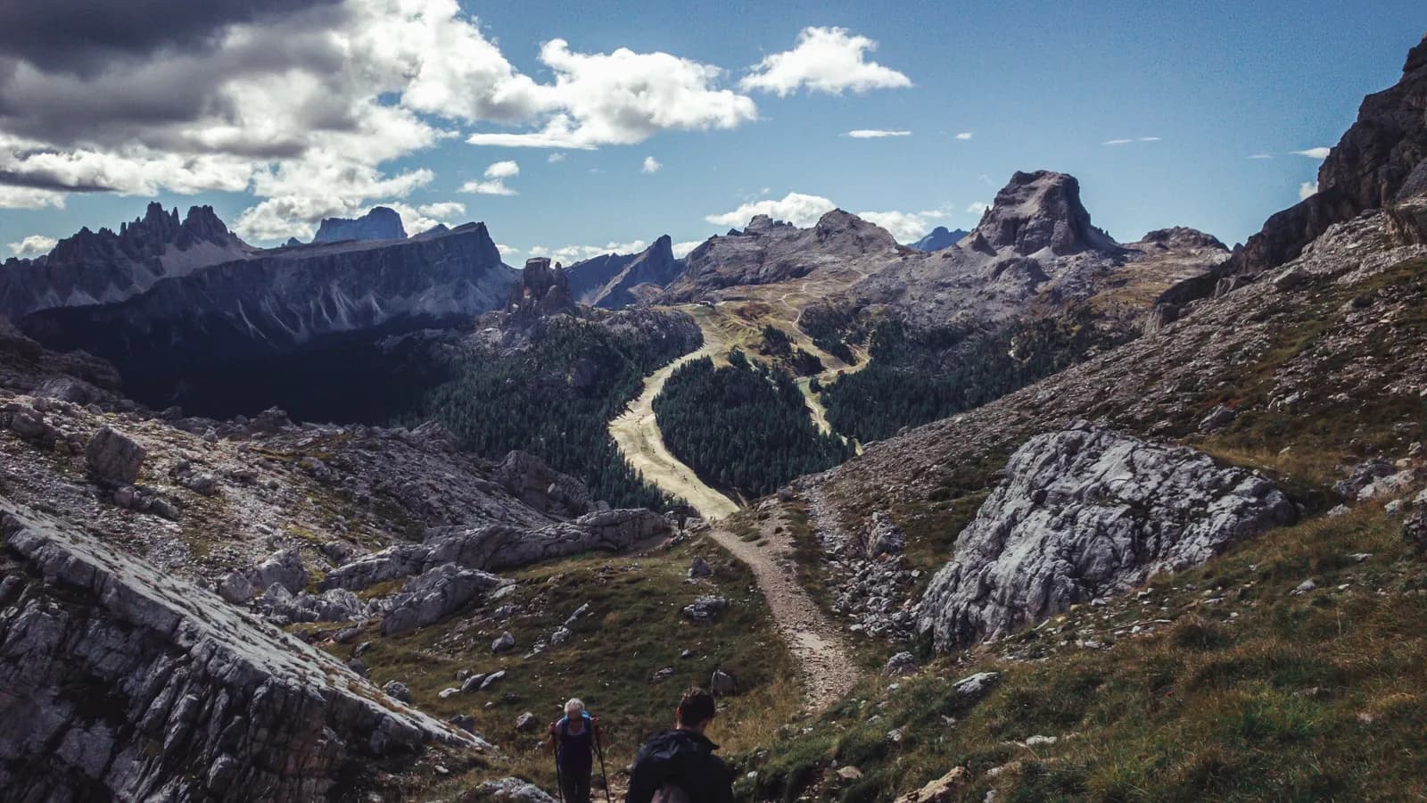 A stony ridge path winding between high rock towers.