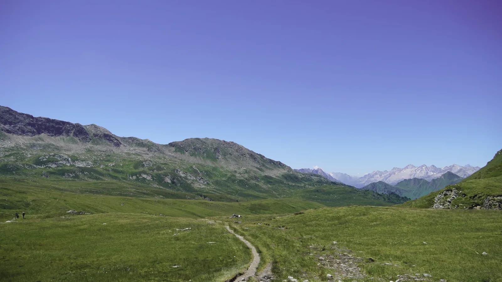 A broad track across an open plateau under a clear sky.